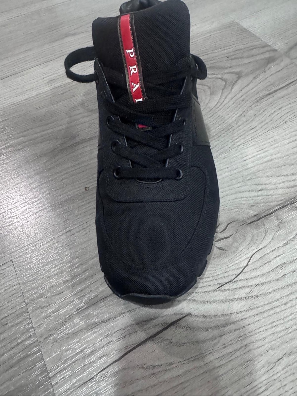 Prada Black Sneaker with Red Tongue Stripe